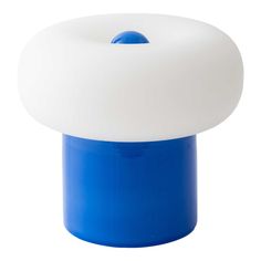 a white and blue object is on a white surface with a light in the middle