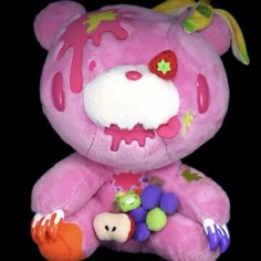 a pink teddy bear with splattered paint on it's face