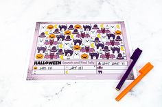 a halloween checklist with markers and pencils on a marble surface