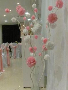 a vase filled with pink and white flowers on top of a table next to a mirror