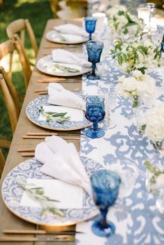 the table is set with blue and white plates