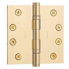 a brass plated door hinge with four screws on the front and side