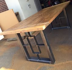 a wooden table sitting on top of a metal frame