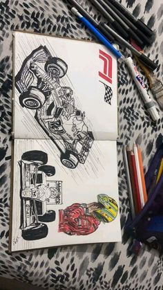 a drawing of a racing car on top of a table next to markers and pencils