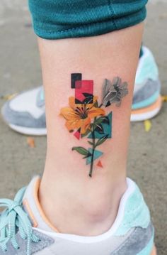 a colorful flower tattoo on the ankle