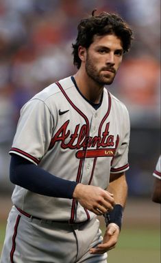 a baseball player holding a bat on top of a field in front of an audience