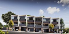 two story apartment building with balconies on the second floor and several cars parked in front