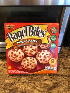 bagel bites frozen pizzas are sitting on the counter in front of an oven