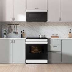 an oven in the middle of a kitchen with white cabinets and marble counter tops on both sides