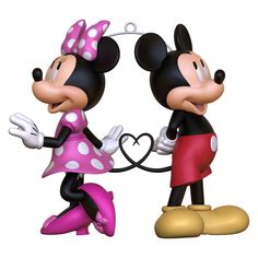 two cartoon mickey and minnie mouses standing next to each other