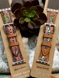 Add a touch of Western charm to your Apple Watch with our Desert Mirage Watch Bands. These stylish bands feature two designs and sizes, each with a tooled brown leather band adorned with cow skulls and cactus motifs in silver. Upgrade your watch and show off your unique personality with these one-of-a-kind bands! 38/41mm or 42/45mm Cactus Motif, Smart Watch Bands, Desert Mirage, Cow Skulls, Craft Things, Leather Ideas, Patriotic Crafts, Cow Skull, Shopify Theme