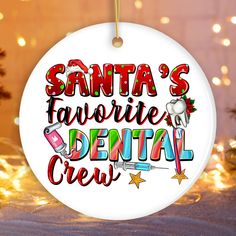 santa's favorite dental crew ornament hanging from a christmas tree with lights in the background