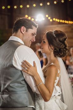 a bride and groom dance at their wedding reception