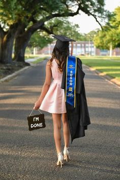 a woman in a graduation gown is walking down the street