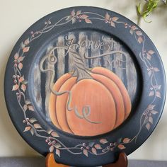 a painted plate with a pumpkin on it