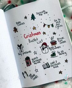 an open notebook with christmas stickers on the pages and writing in red, white and green