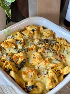 a casserole dish with cheese and spinach