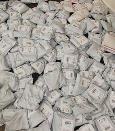 a pile of white bags sitting on top of a wooden floor