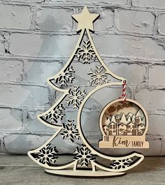 a laser cut christmas tree with a candle on it and the words, merry family