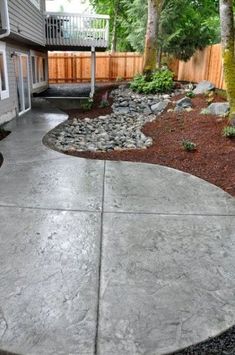 a concrete walkway in front of a house