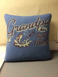 a blue pillow with the words grandpa and gone fishing on it