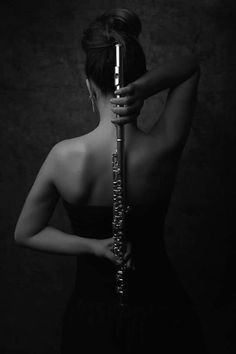 a woman in a black dress holding a flute