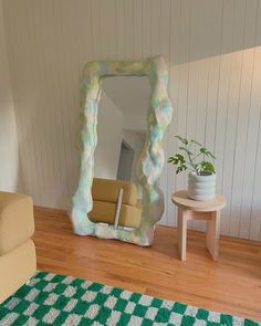 a living room filled with furniture and a large mirror in the middle of the room