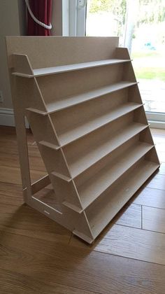 a cardboard shelf sitting on top of a hard wood floor