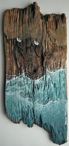 a piece of wood that has been carved to look like a tree stump with water and birds on it