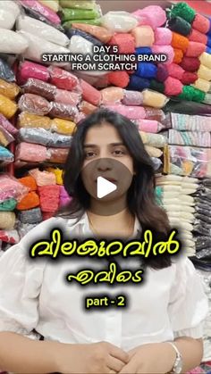 a woman standing in front of a pile of clothes