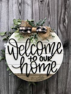 welcome to our home sign with burlocks and greenery