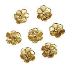 six gold flower shaped buttons on a white background