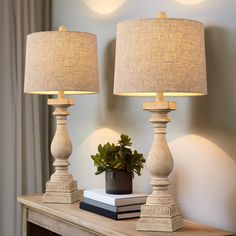 two lamps sitting on top of a wooden table