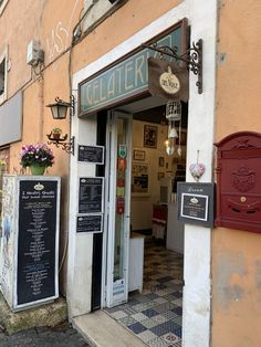 the outside of a restaurant with menus and mailboxes on the front door