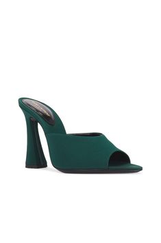 Find SAINT LAURENT Suite Mule Sandal In Dark Green on Editorialist. Saint Laurent Suite Mule Sandal in Dark Green Satin fabric upper and leather sole. Made in Italy. Pointed toe. Flared heel. Padded insole. Approx 100mm/ 4 inch heel. SLAU-WZ1160. 766829-AAAKY-3017. About the designer: SAINT LAURENT has been influencing and revolutionizing the fashion industry since the debut of its iconic ‘Rive Gauche’ collection in 1966 - the couture house was the first to create a ready-to-wear capsule. The sleek, precisely tailored staples, like the signature biker jackets, transcend seasons and trends. Creative Director Anthony Vaccarello continues to honor the label’s illustrious reputation by reintroducing cult styles, including the ‘Lou’ handbag and ‘Tribute’ sandals. Green Heels With Sculpted Heel And Single Toe Strap, Green Open Heel Mules For Party, Green Open Toe Formal Mules, Elegant Green Mules For Evening, Green Open Toe Sandals With Sculpted Heel, Green Pointed Toe Sandals With Removable Insole, Green Block Heel Mules For Party, Green Pointed Toe Mules With Padded Heel, Green Open Heel Mules For Evening