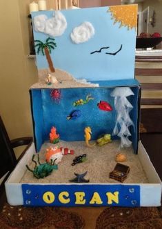 an ocean scene made out of cardboard and sand