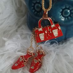 Women's Pendant And Goldtone Chain Necklace Red Purse And Red Heels Dangle Pendant Chain Measures 24" Dangle Pendant Hangs About 3" Purse Measures 1 1/4" Across Beautiful Piece! Trendy Red Adjustable Chain Necklace, Trendy Red Chain Necklace For Gift, Red Metal Charm Necklace With Adjustable Chain, Shoe Pendant, Red Purses, Red Heels, Red Hats, Girl With Hat, Red Gold