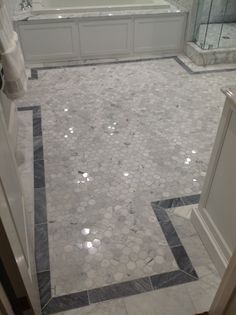 a bathroom with marble floors and white walls