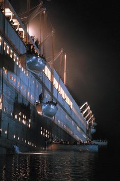 a large cruise ship in the water at night