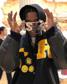 a man wearing a hoodie covering his face with chains