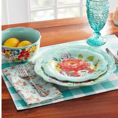 a table set with plates, bowls and utensils