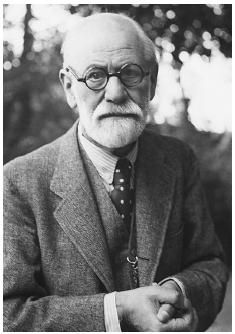 black and white photograph of an old man with glasses wearing a suit jacket and tie