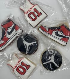 four decorated cookies in the shape of air jordan shoes