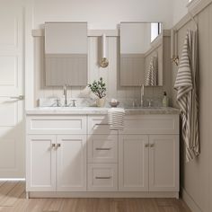 a white bathroom with two sinks and mirrors