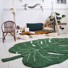 a living room filled with lots of furniture and decor on top of white flooring