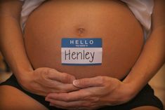 a pregnant woman holding her belly with the word henley written on it