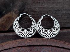 Stunning silver mandala hoop earrings. Featuring intricate, nature-inspired geometric patterns, these earrings offer the perfect balance of boldness and grace. Whether you wear them over tunnels or on their own, they're a versatile statement piece for any occasion. These earrings are plated in 925 sterling silver with 5 microns thickness. Nickel and lead free. Hole Size: 2 mm / 12 ga Dimension: H 70mm W 63mm Weight: 18 g. each * SOLD BY PAIR * The model matches it with this fabulous choker: http Bohemian Round Hoop Earrings, Hypoallergenic, Bohemian Round Hypoallergenic Hoop Earrings, Bohemian Sterling Silver Hypoallergenic Hoop Earrings, Silver Hypoallergenic Hoop Earrings For Festivals, Bohemian Circle Hoop Earrings, Hypoallergenic Festival Hoop Earrings, Hypoallergenic Round Hoop Earrings For Festivals, Bohemian Hypoallergenic Hoop Earrings For Festivals, Bohemian Geometric Nickel-free Jewelry