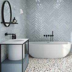 a white bath tub sitting next to a sink in a bathroom under a round mirror