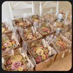 several boxes filled with cupcakes sitting on top of a table