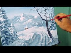 a person is painting a snowy landscape on a canvas with the words time - lapse version